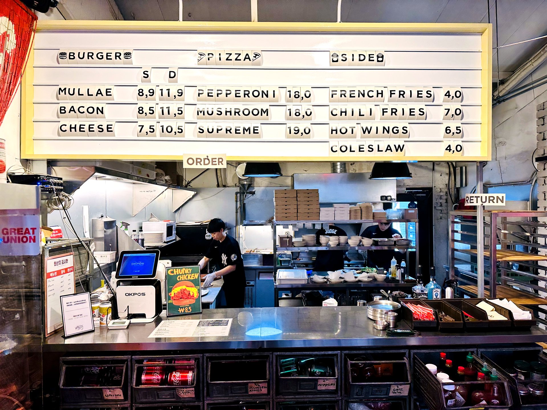 Yankees Burger order counter and bilingual menu board