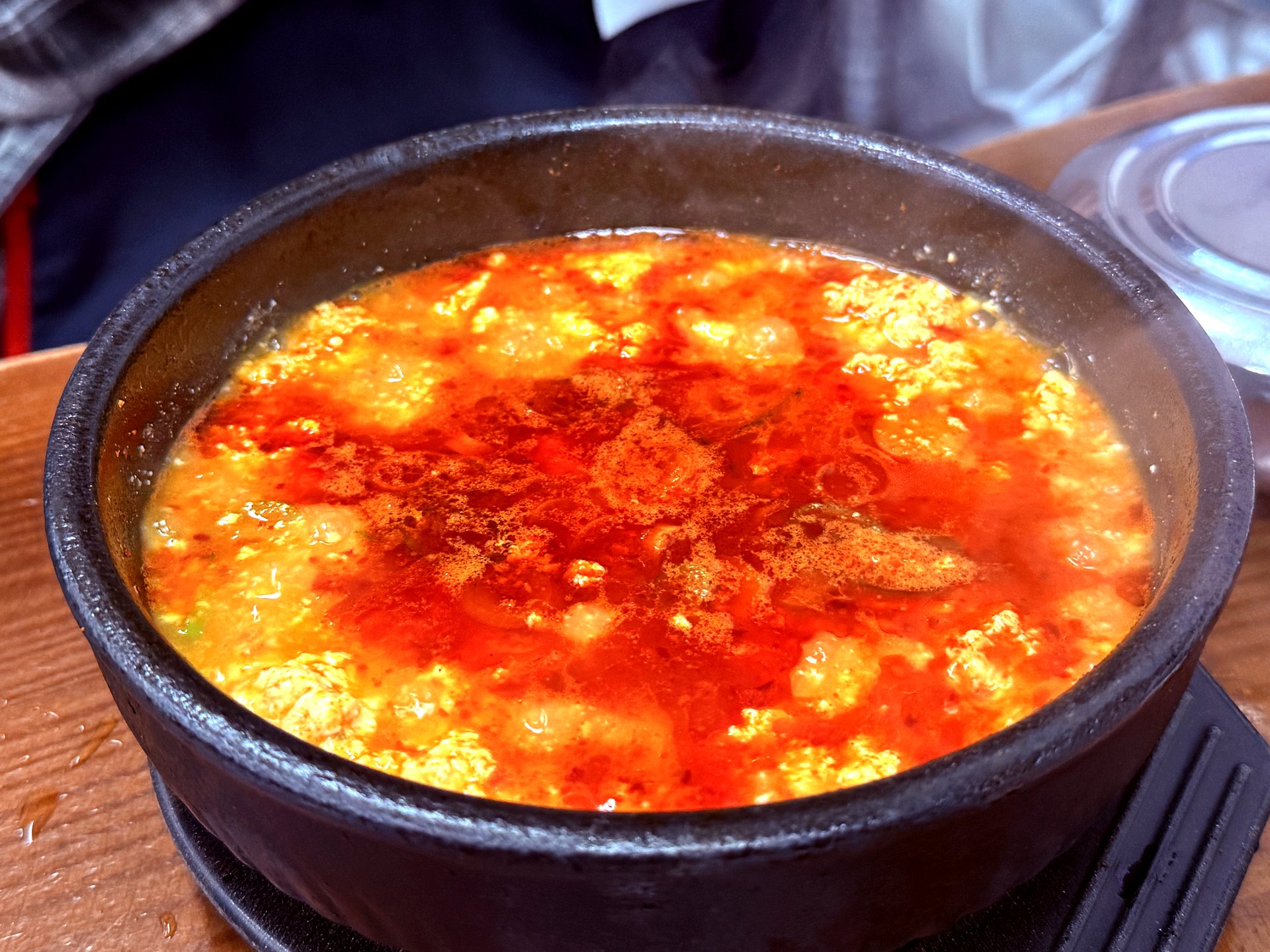 Sundubu jjigae top-down with silky soft tofu in red broth