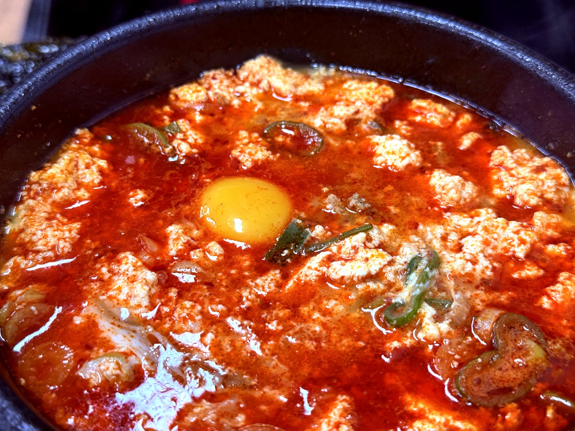 Sundubu with raw egg yolk dropped in close-up