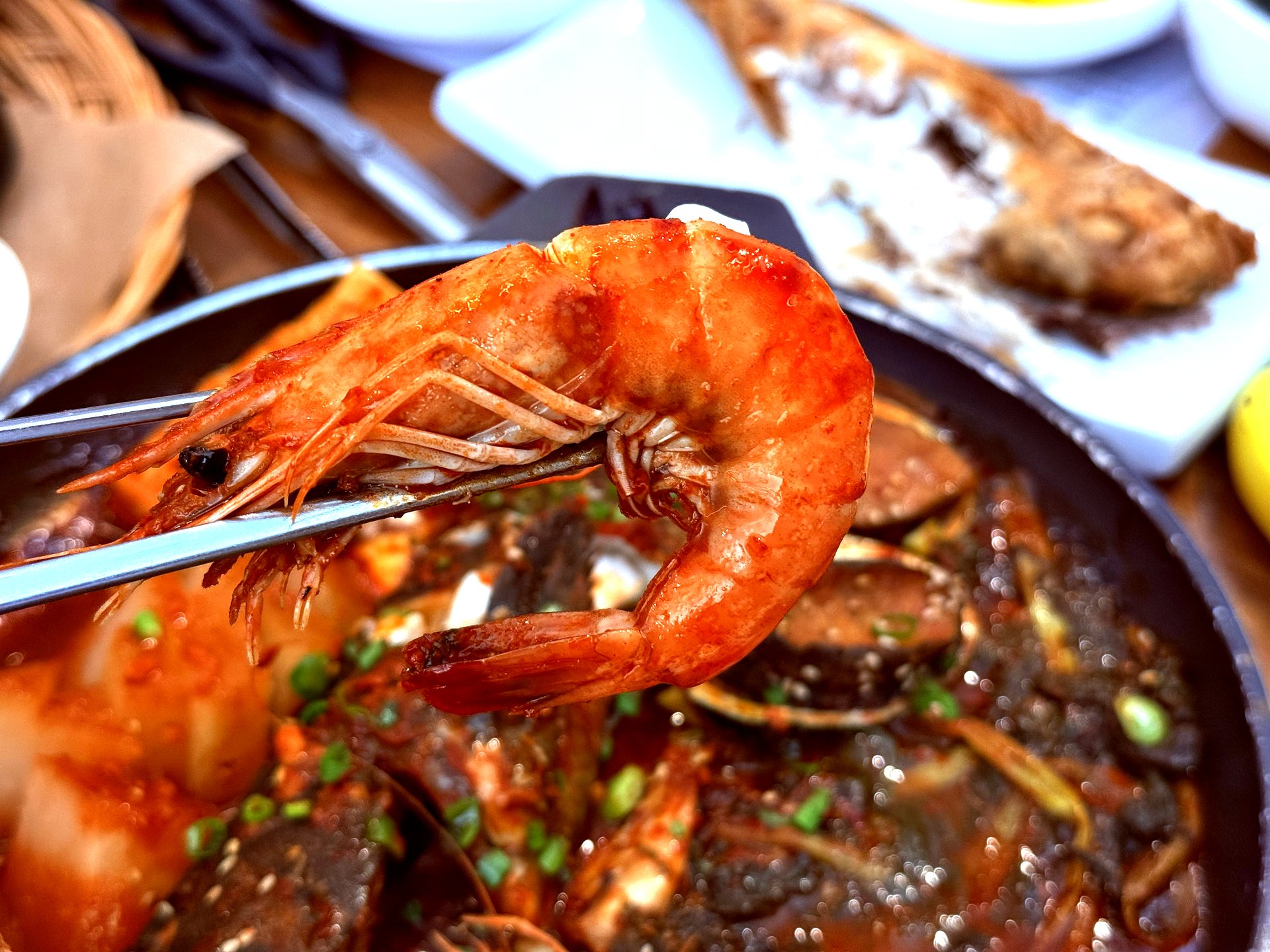 Whole shrimp on chopsticks