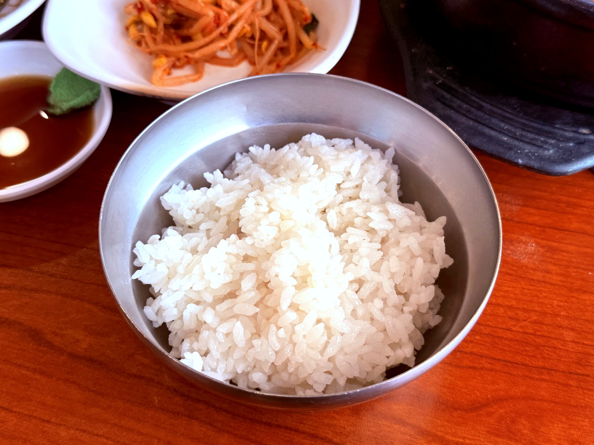 Stainless steel bowl of fluffy white rice