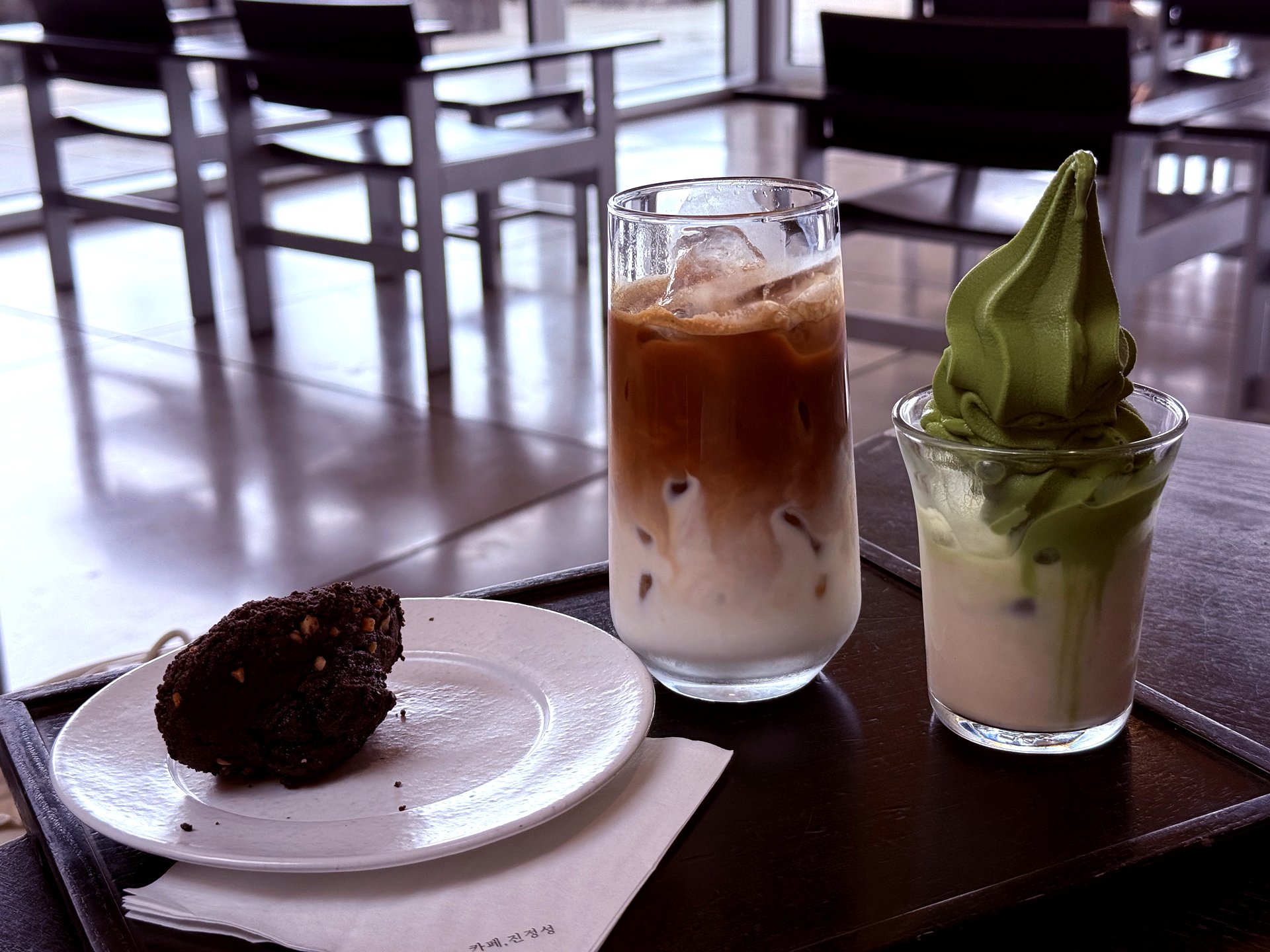 Three signature orders: latte, Earl Grey milk tea with matcha, and volcanic madeleine