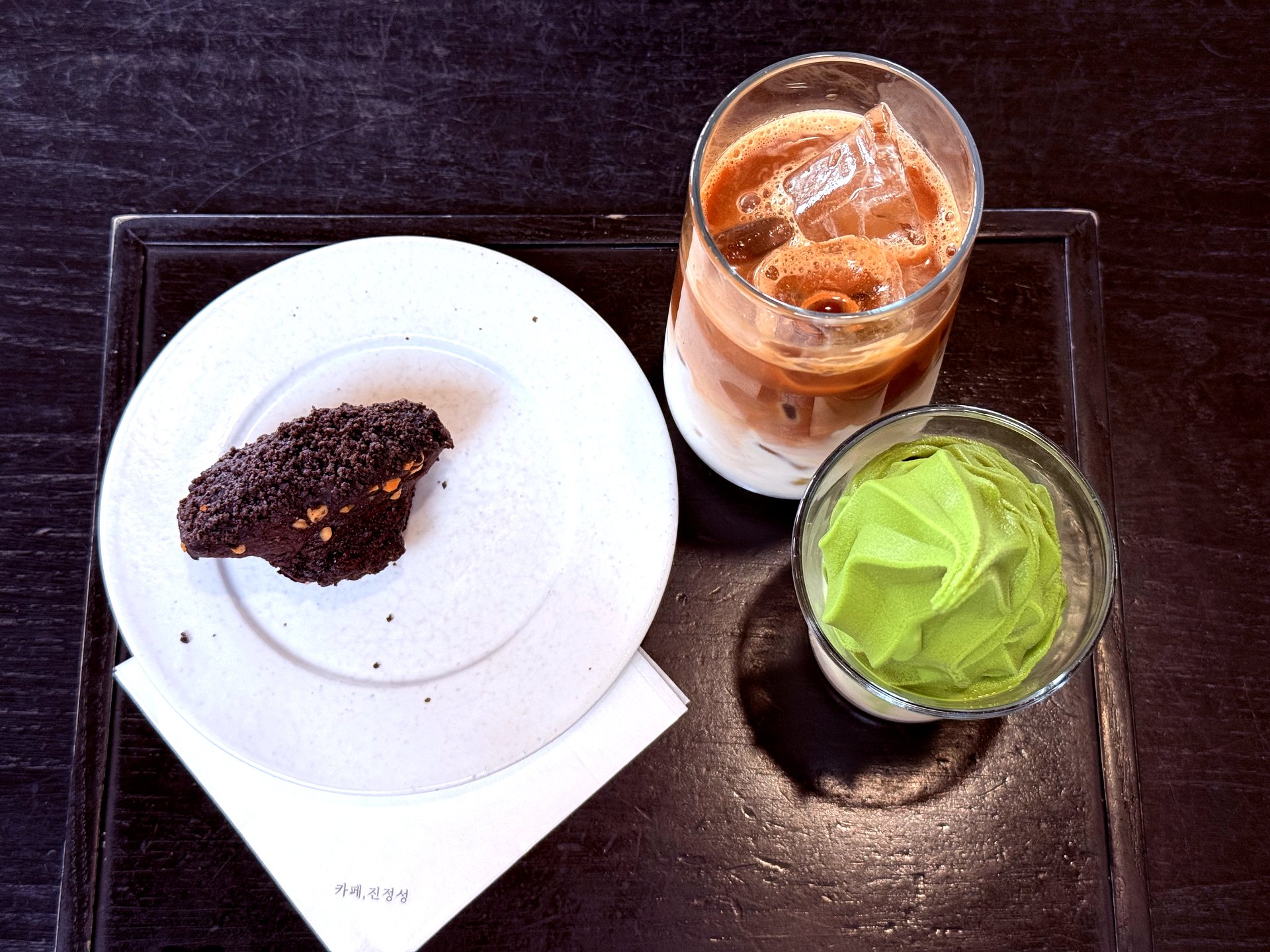 Top-down view: volcanic madeleine, latte, Earl Grey milk tea with matcha