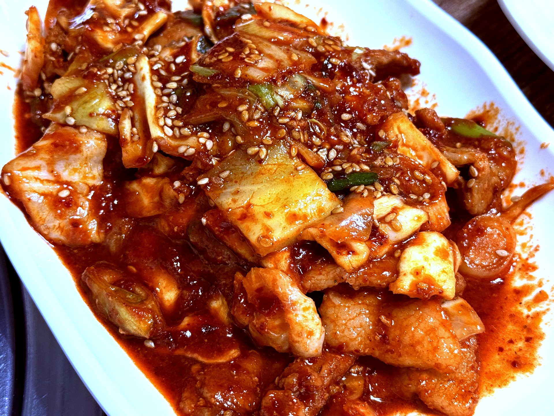 Jeyuk-bokkeum spicy stir-fried pork on white plate