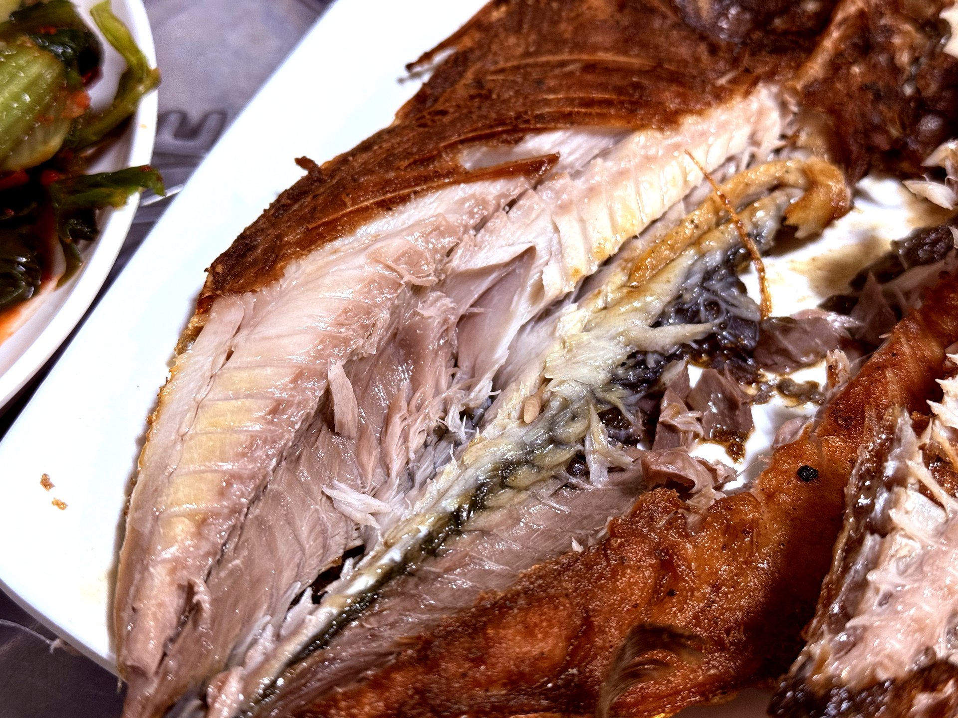 Mackerel flesh inside - flaky white meat next to crispy skin