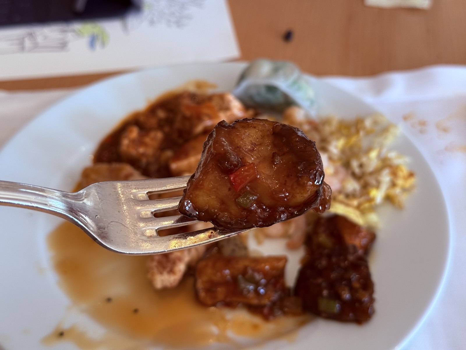 Braised eggplant cube on fork - glossy soy-garlic sauce coating