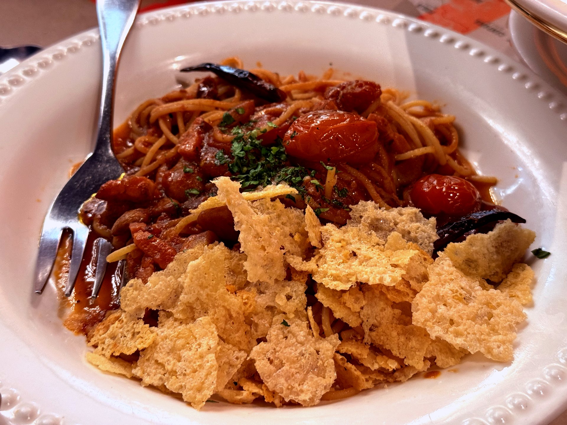 Amatriciana with parmesan-cheese crisp on top