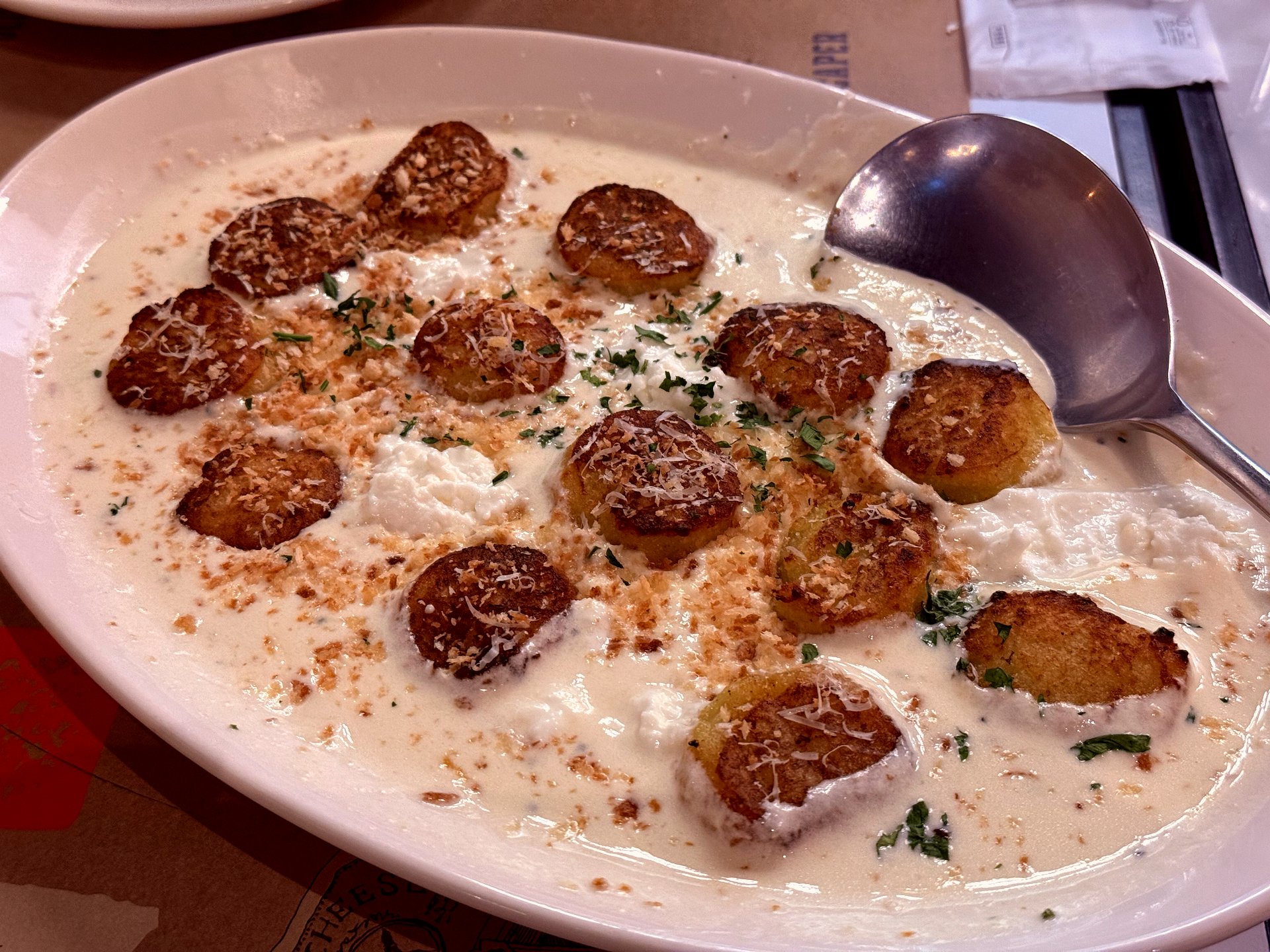 Cacio e Pepe gnocchi with browned tops and ricotta dollops