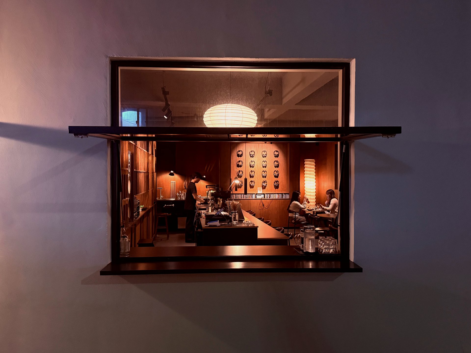 The interior framed through a single window from outside