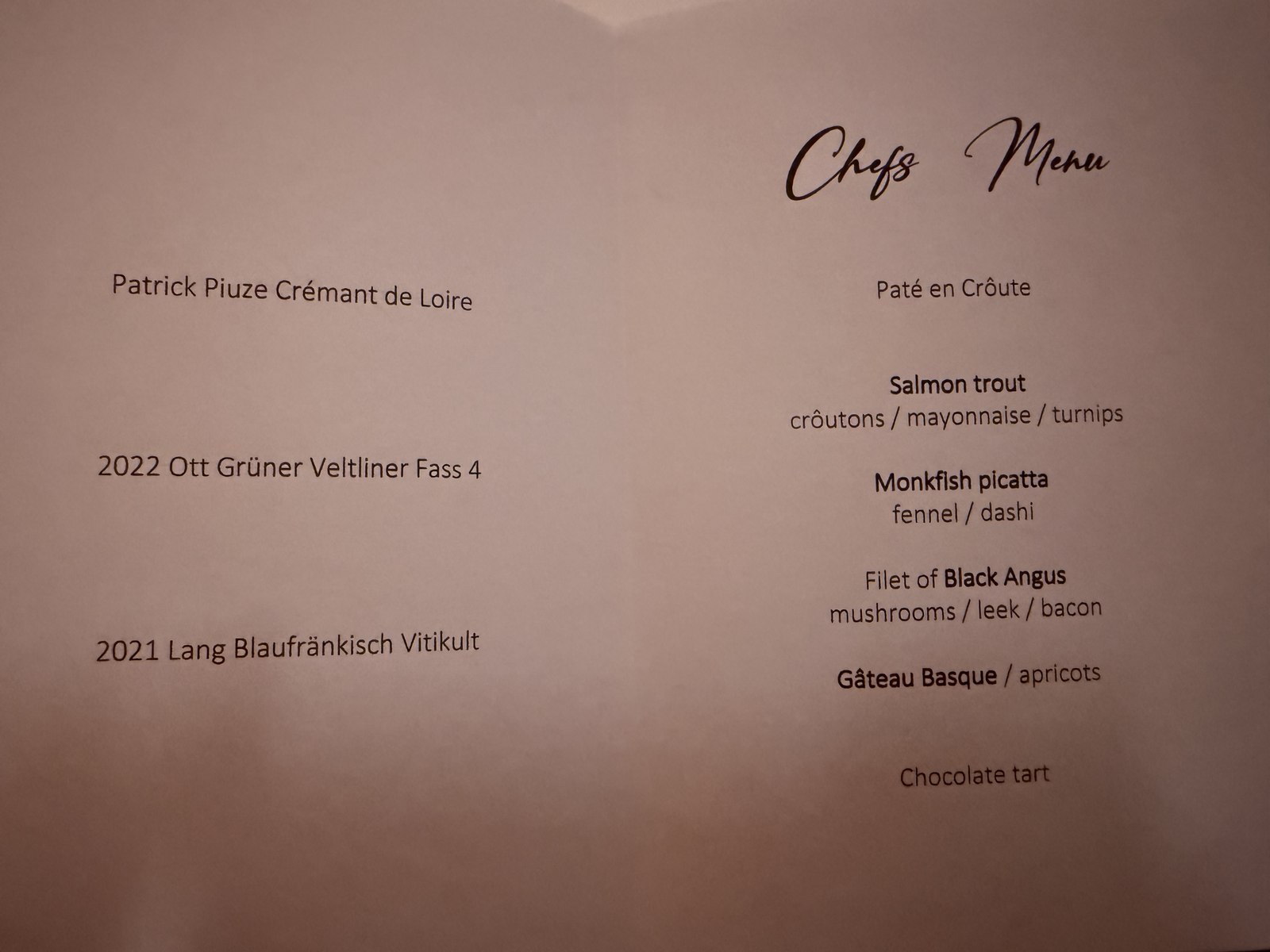 Restaurant Duchardt Chef's Menu printed card - elegant calligraphy header reading 'Chefs Menu' with six dishes listed in two columns - left side shows wine pairings (Patrick Piuze Crémant de Loire, 2022 Ott Grüner Veltliner Fass 4, 2021 Lang Blaufränkisch Vitikult) and right side shows courses (Paté en Croûte, Salmon trout, Monkfish picatta, Filet of Black Angus, Gâteau Basque, Chocolate tart)
