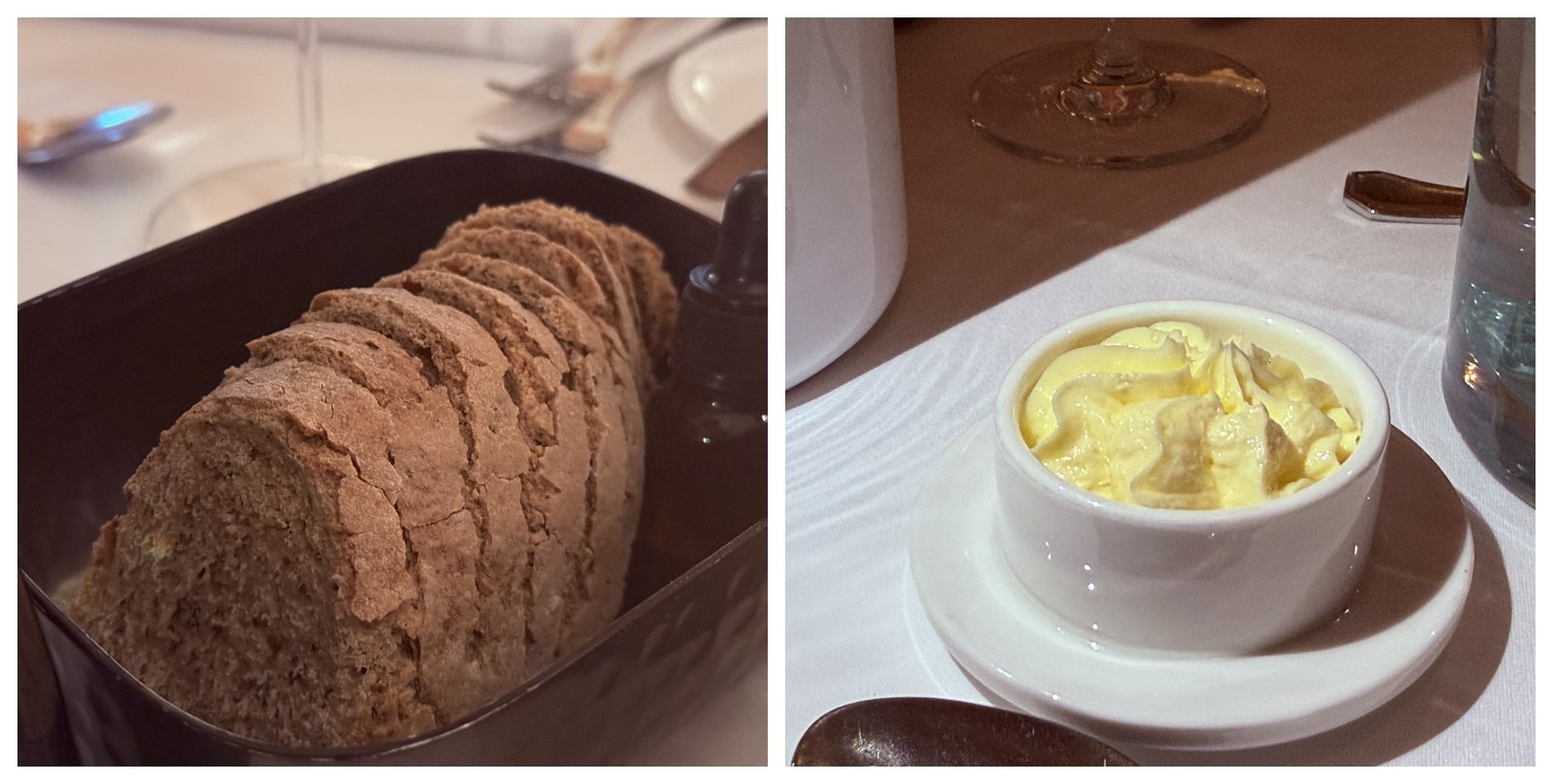 Two angles of Restaurant Duchardt bread and butter service - sliced dark sourdough rye loaf in a black ceramic tray with an olive oil dropper bottle on a white linen table, and a small white ramekin of whipped house butter with peaks on a matching saucer