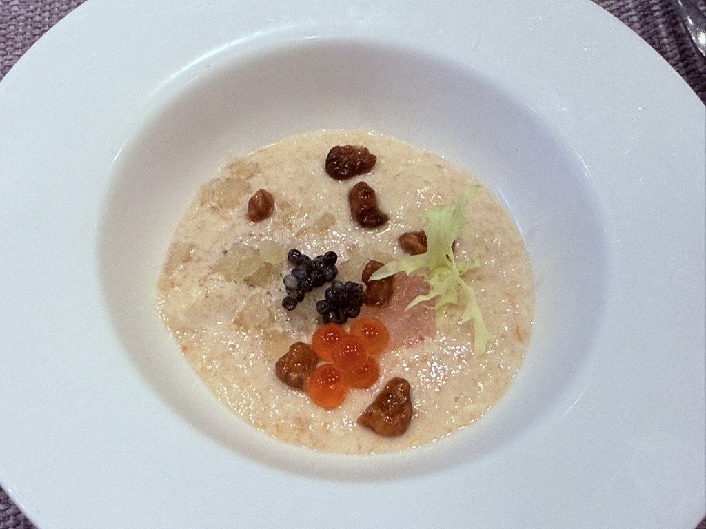 Naedang caviar with persimmon soy jelly - creamy seafood velouté base topped with black caviar, orange salmon roe, candied walnuts, smoked salmon ribbon, diced persimmon, and a green endive leaf
