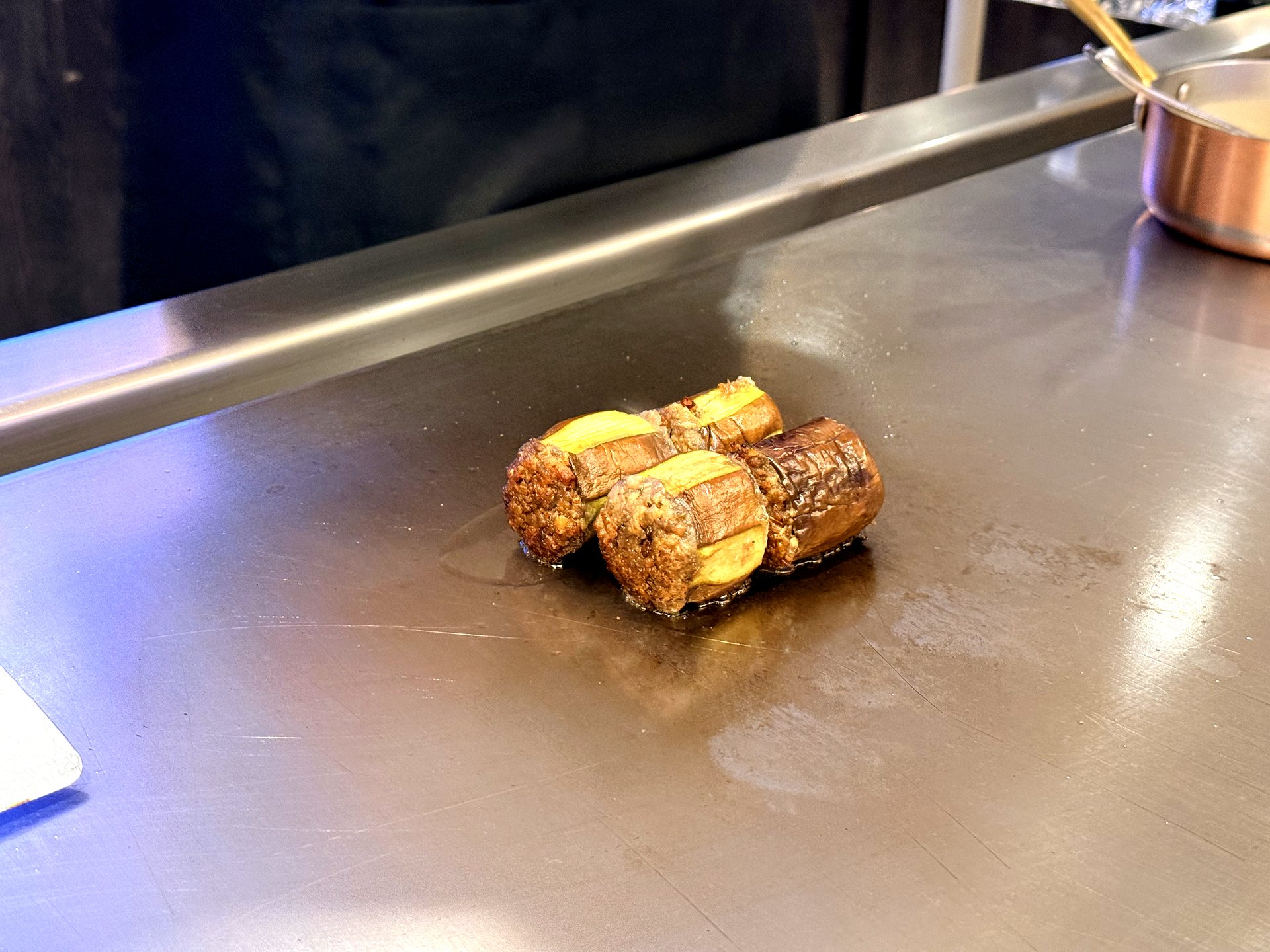 Course two at Kawabe Teppanyaki Seoul - grilled seasonal vegetables, cylinders of grilled eggplant wrapped around a savory filling, caramelized on the steel teppanyaki griddle