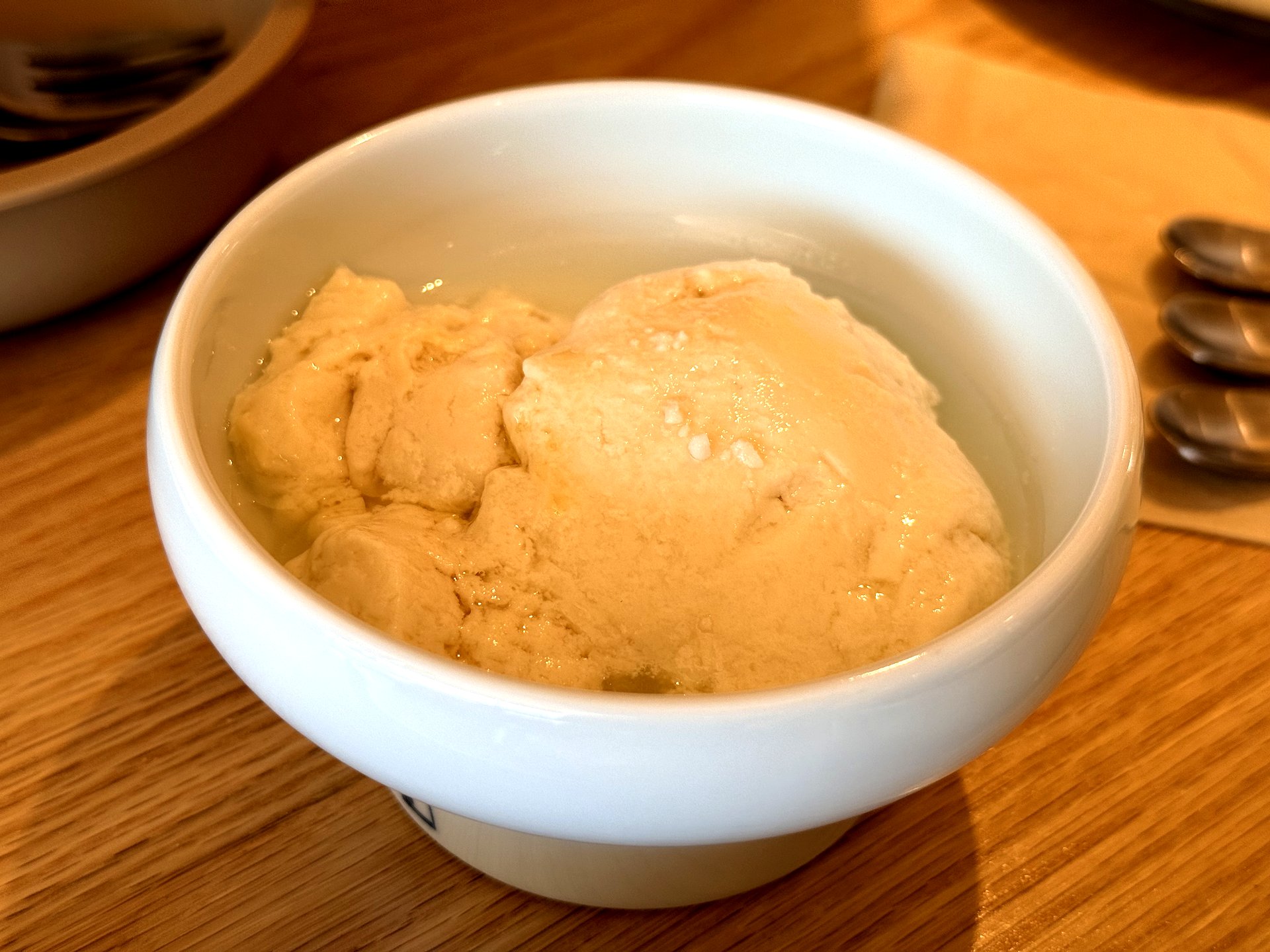 A bowl of Ondang's fresh house-made soft tofu (sundubu) - pale, soft, glistening curds of just-made warm tofu in a white footed bowl
