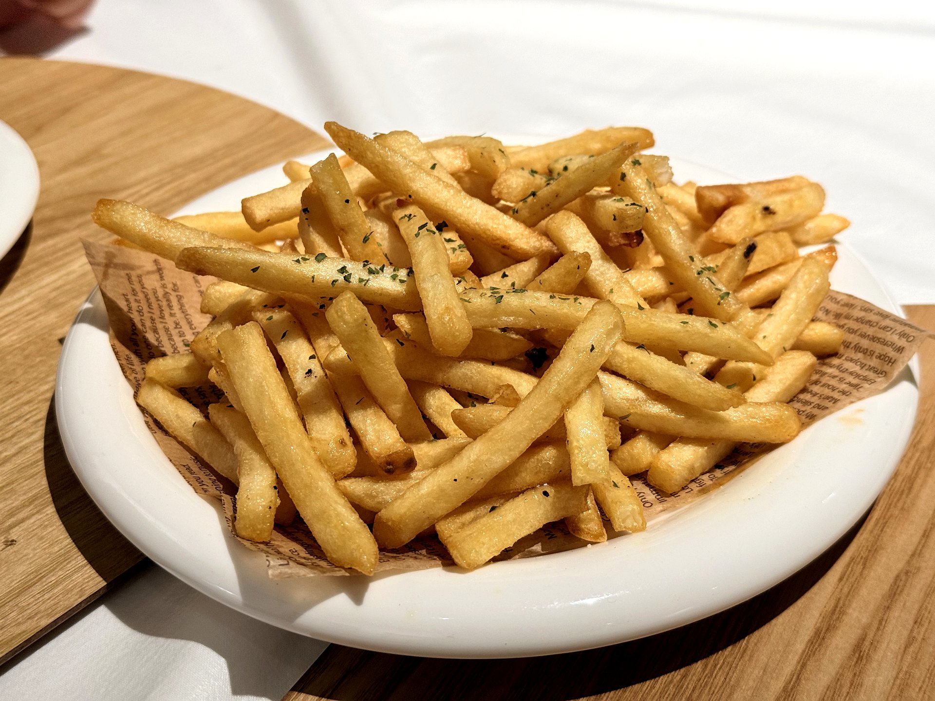 OZ Pizza herb French fries - a plate of hot crisp golden fries dusted with dried parsley at a pizza pub in Aewol, Jeju